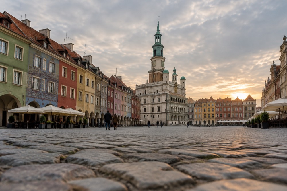 Colorful townhouse facades on the Old Market Square in Poznan at golden hour