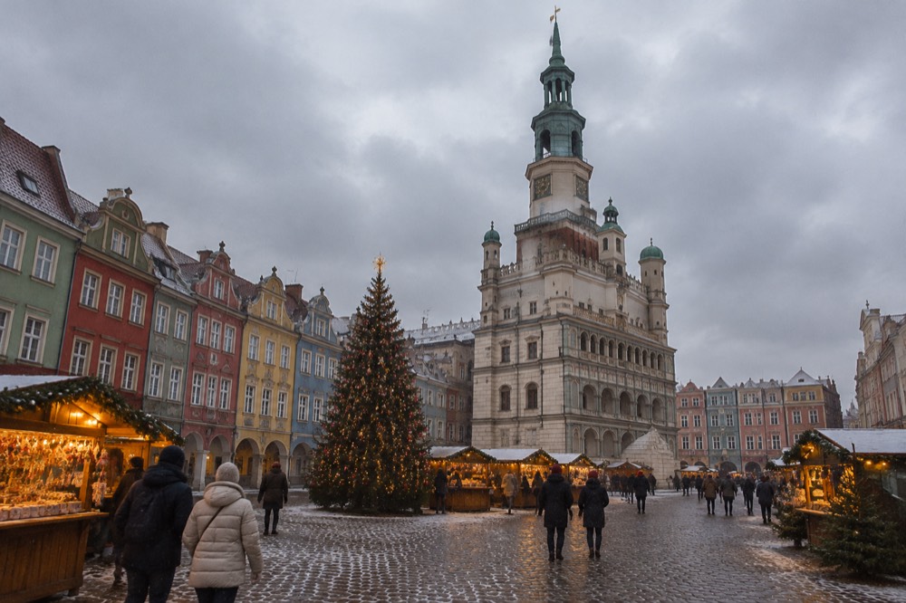 Illuminated Christmas market stalls and a decorated Christmas tree on the Old Market Square in Poznan