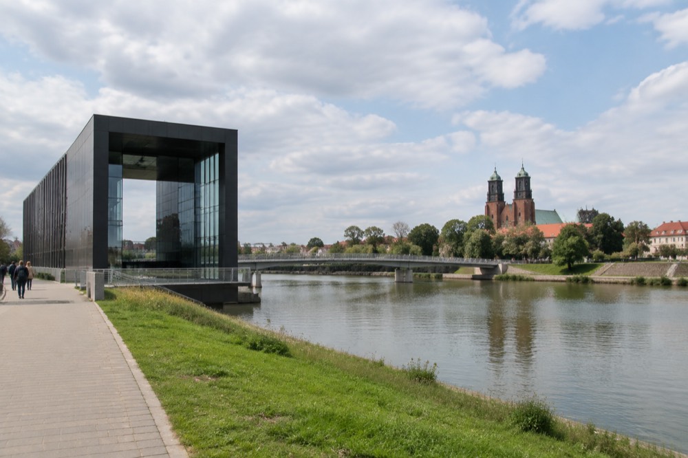 Twin towers of the Poznan cathedral seen across the Warta river from the riverbank