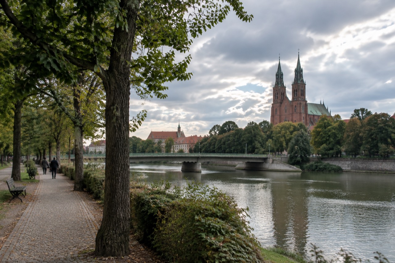 Twin spires of Poznan Cathedral rising above the Warta river and the green island of Ostrow Tumski