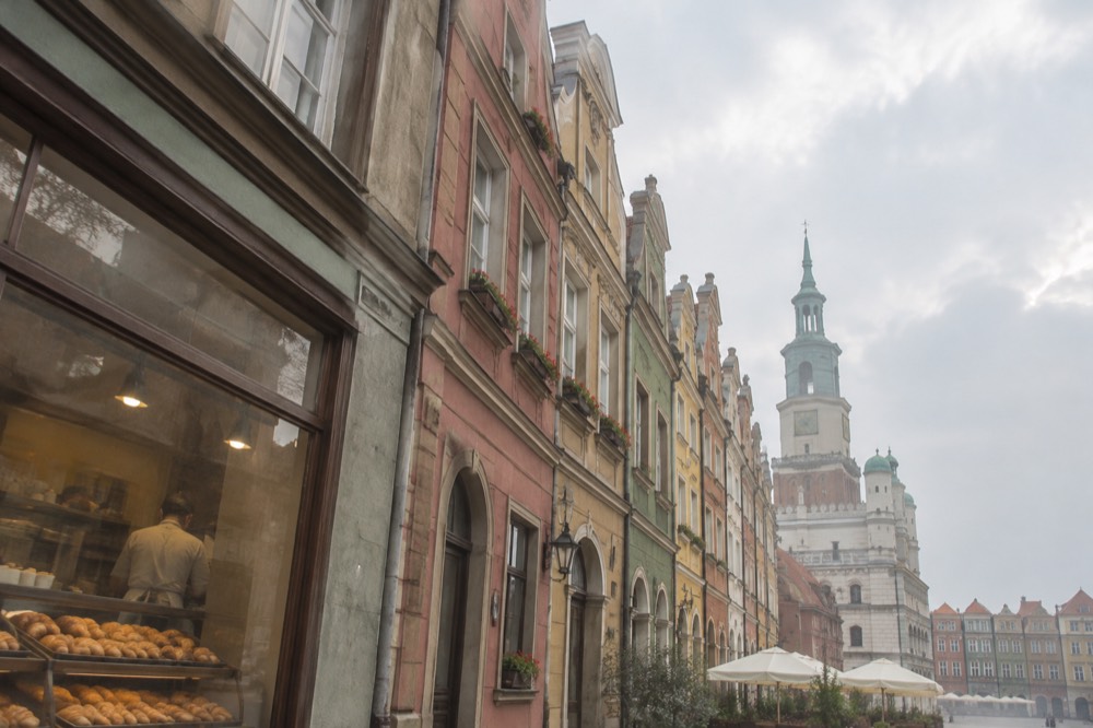 Historic townhouse facades glowing in evening light on a Polish market square