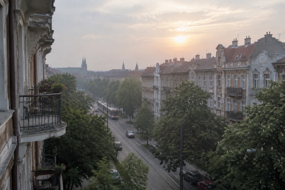Evening light over treetops and rooftops in the Jezyce district of Poznan