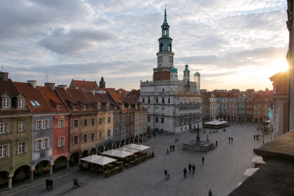 The colourful merchant houses and Town Hall tower of the Old Market Square in Poznan seen from a corner
