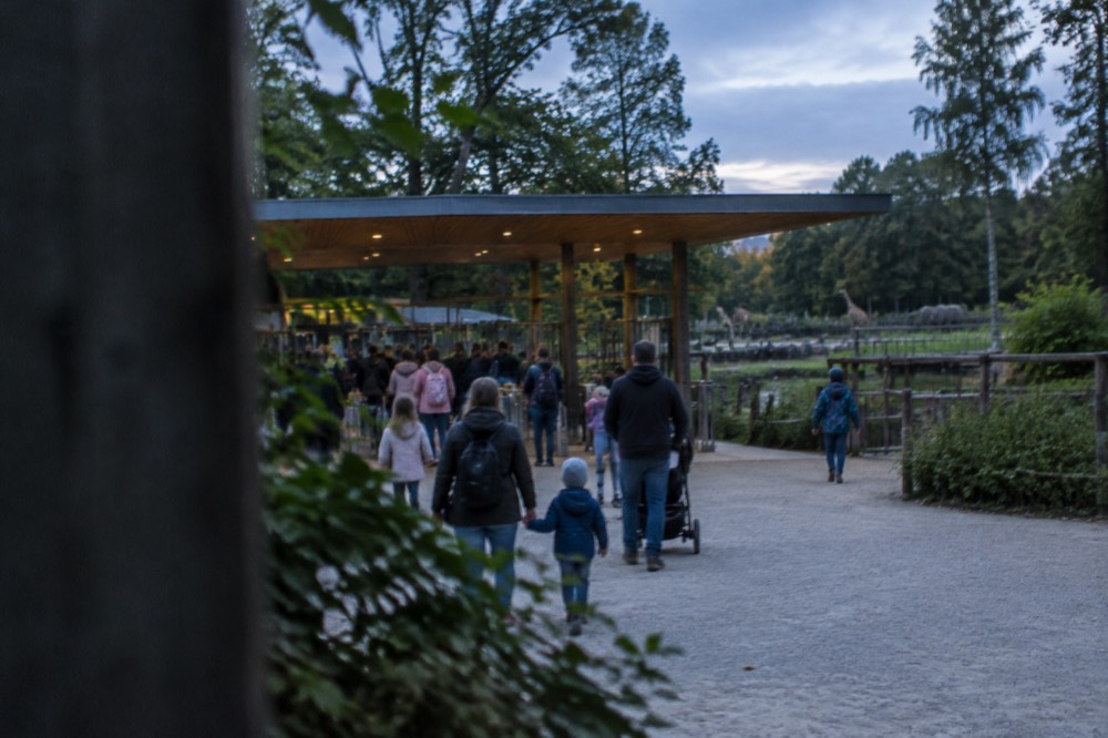 The entrance area of the Poznan New Zoo with families queuing at the ticket gates