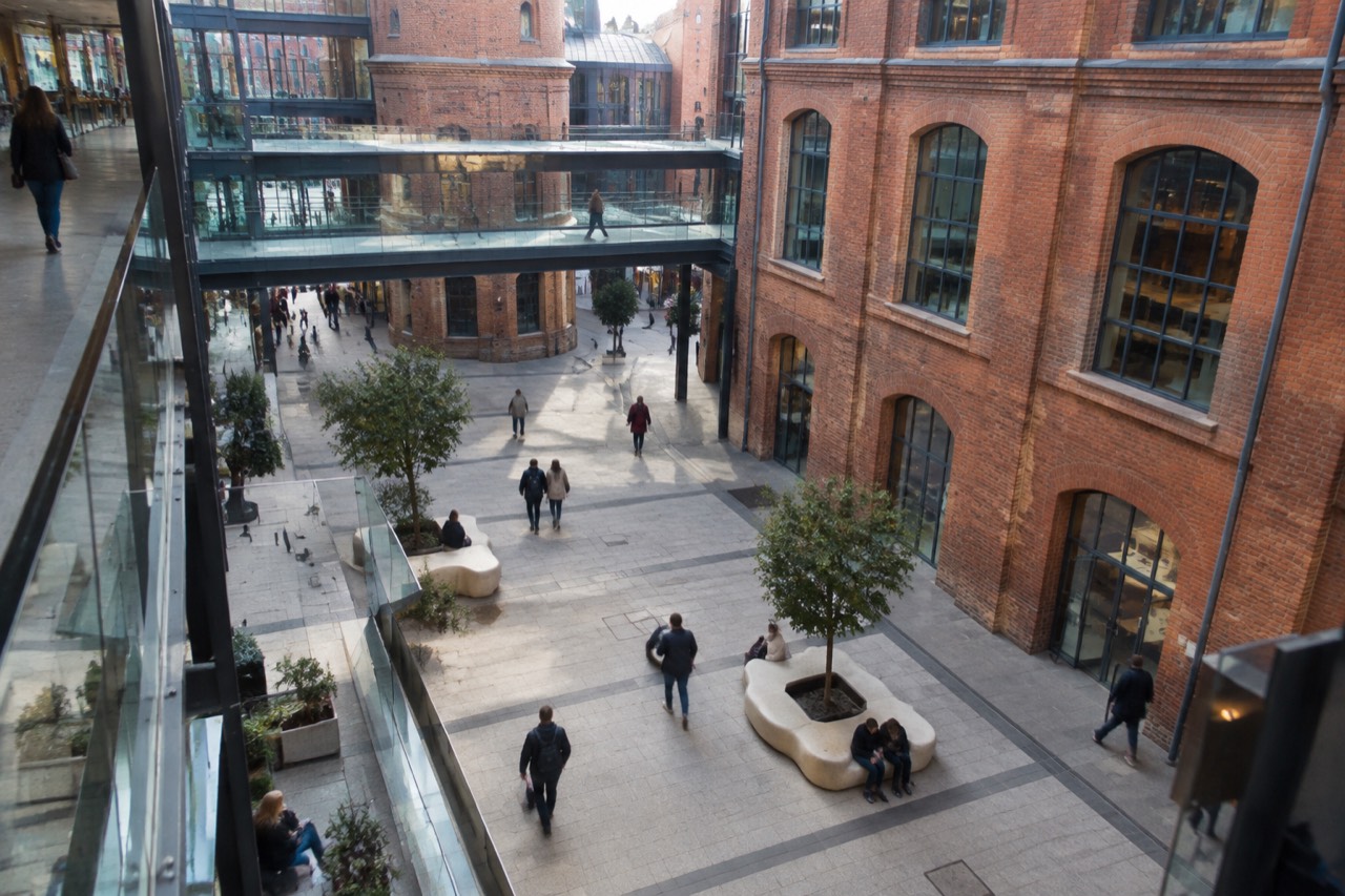 The atrium of Stary Browar in Poznan with galleries rising above a brewery courtyard