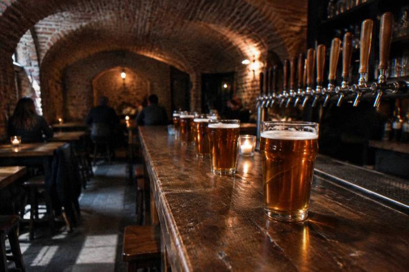 Glasses of amber beer in a brick cellar bar in Poznan